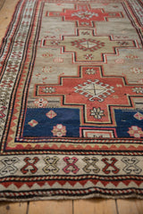 Stepped geometric medallion and crab style border on a vintage Caucasian rug runner.
