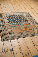 Vintage Caucasian rug's end, displaying geometric border with sand, orange, and blue tones.