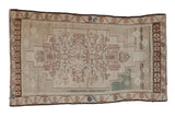 Distressed vintage Oushak rug with ivory field, stepped medallion, muted charcoal vinery. 3'6