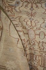 Distressed Oushak rug showing soft, worn pile texture and faded floral vine motifs.
