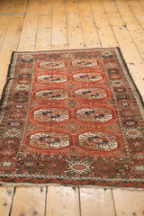 Vintage Afghani Bokhara rug end with madder red field, water border, and fringe.
