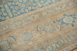 Worn Herati and inverted turtle motifs on distressed Birjand carpet in sky blue and sand.