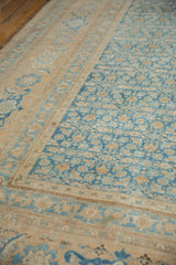 Distressed Birjand carpet showing worn sky blue Herati field and beige border.