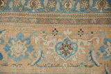 Vintage Birjand carpet showing distressed texture with blue Herati and turtle motifs.