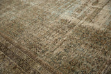 Distressed vintage Mahal carpet's worn pile reveals subtle Herati pattern in muted olive, brown, ivory.