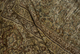Distressed Mahal carpet detail, showing worn Herati motif and abrash in olive and brown.