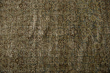 Close-up of distressed Mahal carpet pile with muted olive green Herati pattern and aged texture.