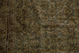 Distressed Mahal carpet close-up, revealing worn Herati motif in olive, brown, and ivory tones.