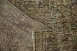 Varied texture, abrash, and earthy tones on a folded vintage distressed Mahal carpet.