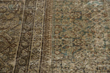 Distressed vintage Mahal carpet close-up, revealing worn Herati motif, abrash, and soft earthy tones.