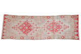 Distressed vintage Oushak runner featuring faded cherry red diamond medallions and a pomegranate border, 3'1
