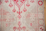 Distressed Oushak runner pile with even wear, faded cherry red, and powder blue motifs.