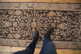 A personal perspective showing the distressed, low-pile texture on a vintage Sparta rug runner.