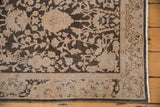 Evenly worn pile of a distressed Sparta rug with intricate beige blossoms on a charcoal background.
