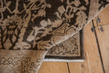 Folded corner of a Sparta rug showing the hand-knotted back and worn, low-pile texture.