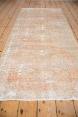 Distressed Oushak runner's low pile with visible foundation, pale terra cotta, ivory.