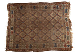Antique Caucasian rug with geometric serrated panels and serpent border in muted earth tones.