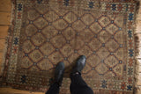 Early 20th century Caucasian rug displaying geometric serrated panel motifs and serpent borders, showing patina.