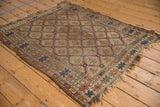 Antique Caucasian rug, beige field, repeating serrated panel design, geometric borders, rich earth tones, visible wear.