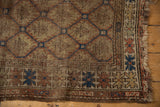Antique Caucasian rug corner with tattered fringe, displaying serpent motif and alternating ground borders.