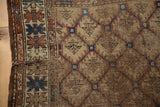 Antique Caucasian rug corner shows tattered edge, pile wear, and serpent border motif.