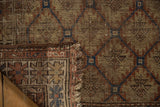 Earthy tones on worn antique Caucasian rug pile featuring plant and panel motifs.