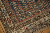 Vintage Caucasian rug corner detail, featuring blue fish motif field and a multi-color boteh border.