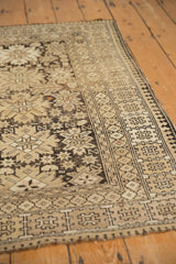 Vintage Caucasian hand-knotted rug with reciprocating pawn border and ivory starburst motifs.