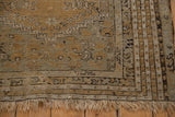 Antique Kula rug corner showing multi-layered border, pearl motif, fringe, and surface wear.