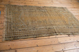 Antique Kula rug side border, with beige, sand, charcoal geometric patterns and even wear.