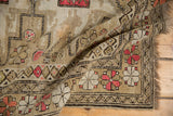 Textured pile, geometric quatrefoil and serpent motifs on this vintage Caucasian rug.