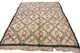 Plush ivory, charcoal, and cherry red geometric diamond pattern on a vintage Moroccan rug.