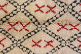 Thick plush ivory pile with charcoal lattice and cherry red X-motifs.