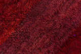 Moroccan carpet's hand-knotted pile with rich wine red and burgundy abrash.