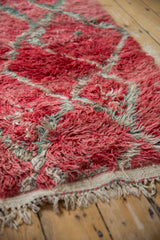 Close view of the hand-knotted pile, foundation, and fringe on a vintage Moroccan carpet.