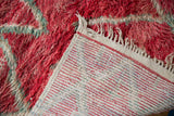 Hand-knotted foundation and plush cherry red pile on a vintage Moroccan carpet corner.