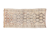 Vintage Moroccan rug runner with ivory field, concentric diamonds, red, saffron, charcoal patterns.
