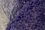 Close-up of vintage Moroccan carpet pile, showcasing rich violet and blue abrash texture.