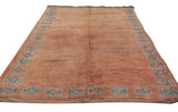 Vintage Moroccan carpet with pale apricot pile and serrated geometric floral border.