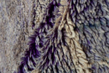 Vintage Moroccan carpet's thick shaggy pile with purple and ivory abrashed tones.