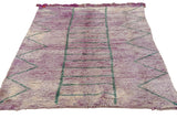 Geometric block and chevron pattern on a vintage Moroccan rug with abrashed violet pile.