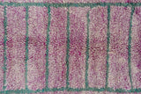 Thick, shaggy pile of vintage Moroccan rug, vibrant purple and muted teal rectangles.