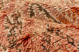 Vintage Moroccan carpet pile showing ivory, tangerine, rust, and chocolate high-low texture.