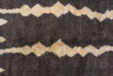 Vintage Moroccan carpet detail showing shaggy charcoal and cream zigzag pattern.