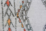 High-low ivory pile texture with abstract charcoal and terra cotta motifs on vintage Moroccan carpet.