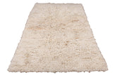 Thick, hand-knotted Tulu rug featuring a shaggy ivory and antique white pile.