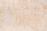 Hand-knotted Tulu rug featuring a plush, thick ivory and antique white pile.