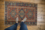 Vintage Karaja rug corner: geometric brick red field, indigo blue border, mostly even wear.