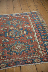 Hand-knotted Persian Karaja rug, brick red and indigo geometric patterns, with subtle pile wear.