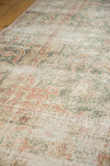 Distressed vintage Sparta carpet pile, worn knot heads, visible foundation, muted green, blush, ivory.
